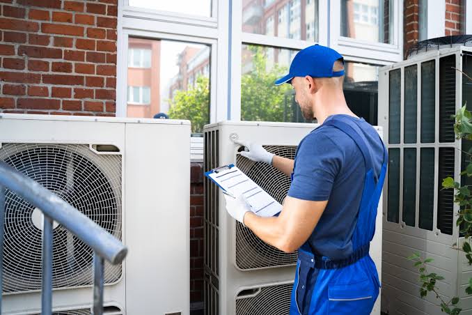 HVAC field technician inspecting residential outdoor equipment