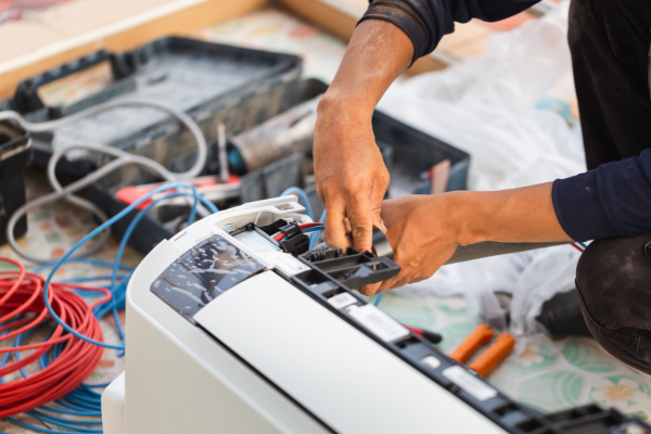 Technician performing an urgent repair on residential climate-control equipment