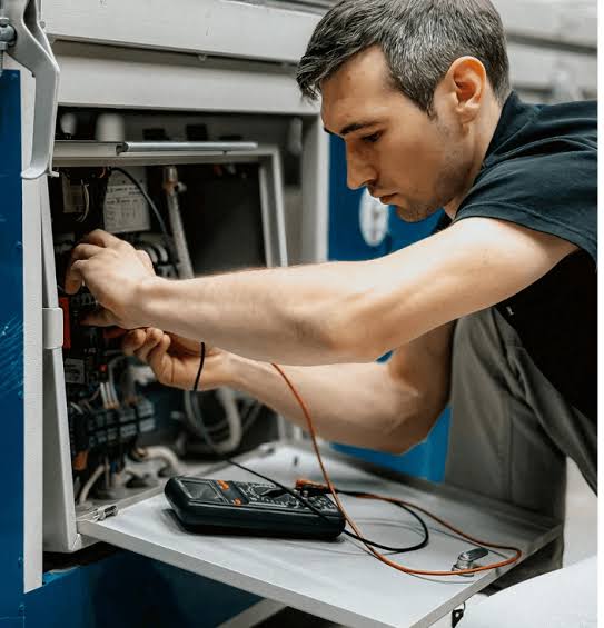 Technician diagnosing residential HVAC electrical components